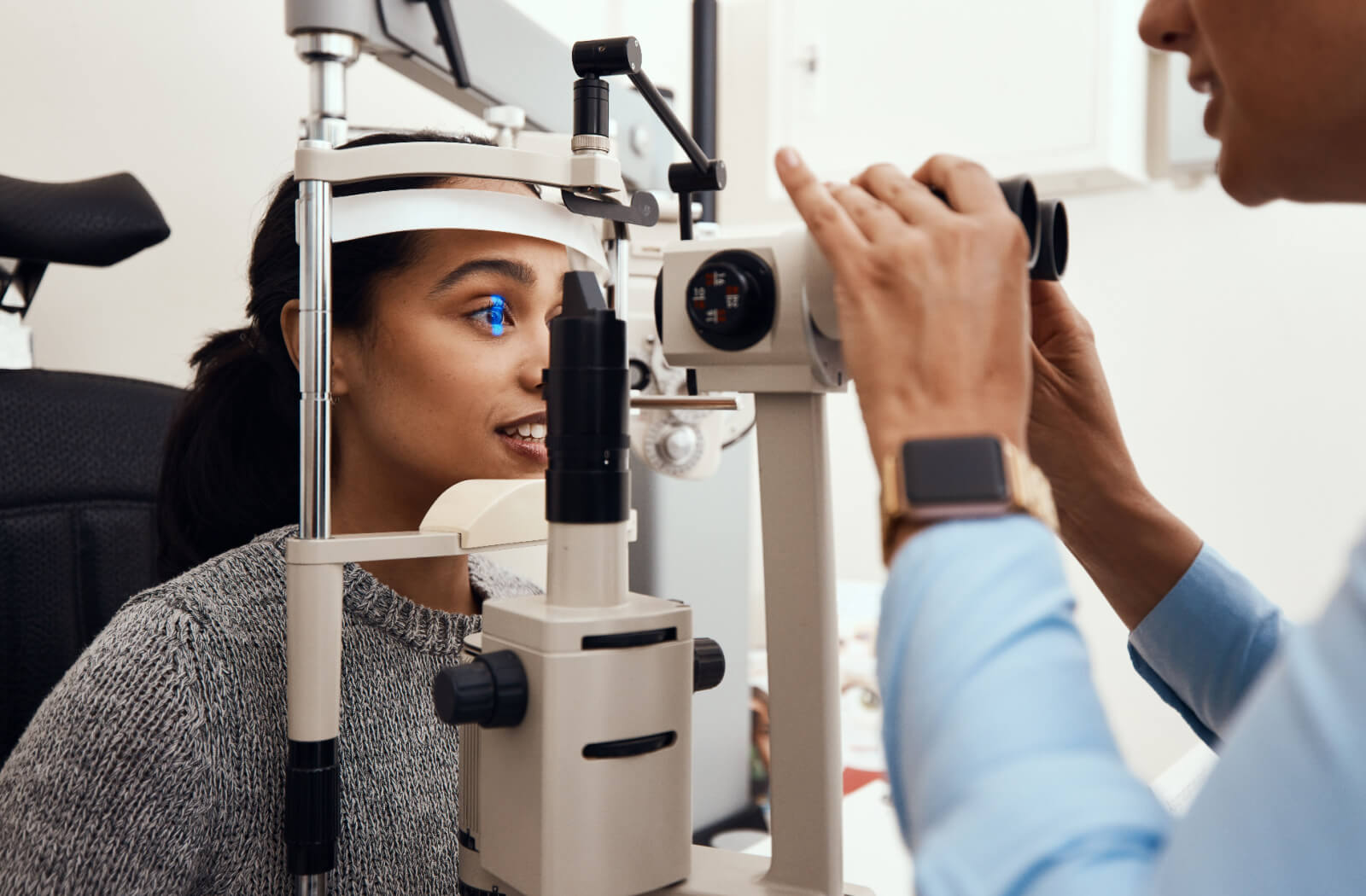 Young woman getting her eyes tested for prescription glasses or contact 