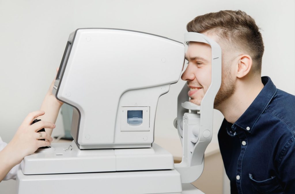 Male patient smiling while receiving an OCT scan