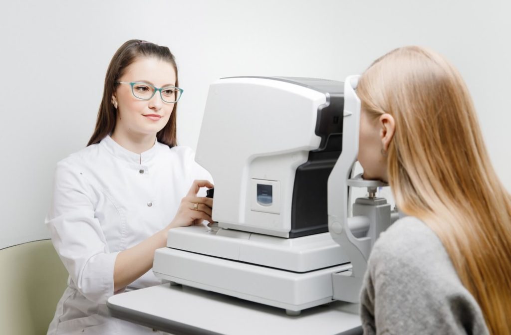 Optometrist conducting an OCT scan on a female patient