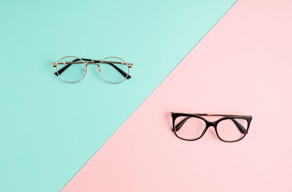 Two pairs of stylish glasses sit on a dual-colour pastel background.