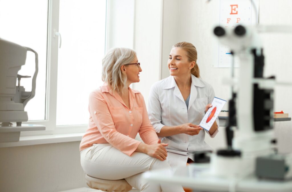 an eye doctor discussing eye health with a patient during a routine eye exam